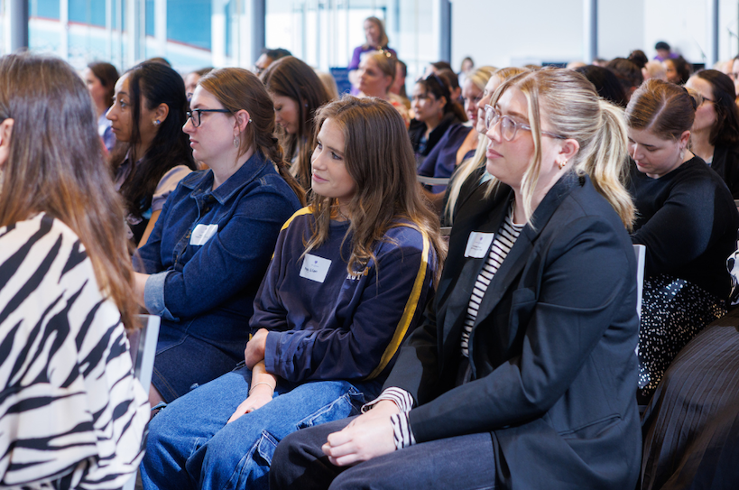 A group of women attentively listening during the Annual Forum on Women and Homelessness